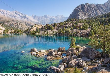 Tajikistan. Turquoise Water In Alaudin Lake. Beautiful View On Rocky Shore Of Lake In Fann Mountains