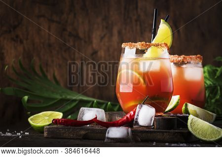 Michelada - Mexican Alcoholic Cocktail With Beer, Lime Juice, Tomato Juice, Spicy Sauce And Spices, 