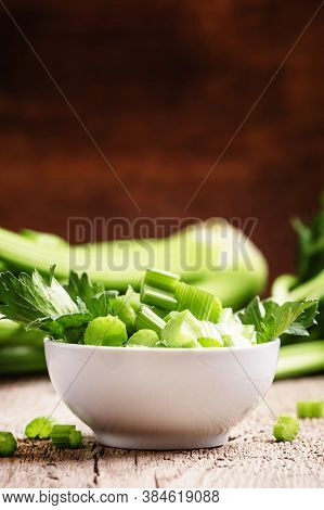 Fresh Sliced Celery In A White Bowl On A Vintage Wooden Background, Selective Focus
