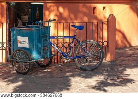 Leon, Nicaragua - November 27, 2008: Blue Garbage Collection Tricycle Parked In Front Of Orange And 