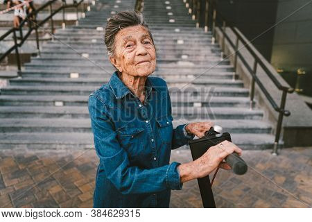 Old Woman Near Scooter. Grandmother Progressive Woman. Senior Having Fun. Old Woman Enjoying Her Hob