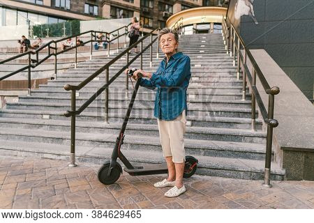 Old Woman Near Scooter. Grandmother Progressive Woman. Senior Having Fun. Old Woman Enjoying Her Hob