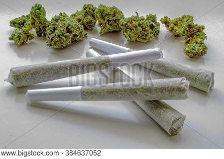 Several Pre-rolls Of Medicinal Cannabis With Flower Cannabis On The Background