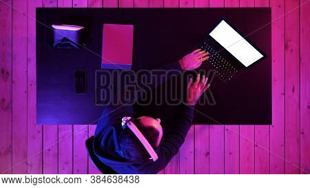 Professional Gamer Playing Video Game On His Laptop. White Displ