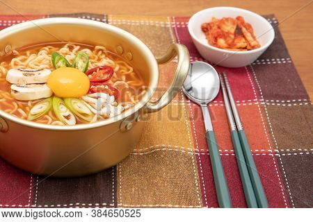 Serving A Korean Style Instant Noodle, Ramyeon With Egg Yolk, Chilli, Kimchi In A Traditional Korean