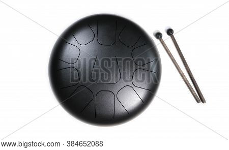 Top View Of  Steel Tongue Drum With Drum Sticks On White