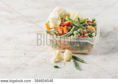 Frozen Vegetables: A Mix Of Vegetables, String Beans And Cauliflower In A Plastic Container For Free