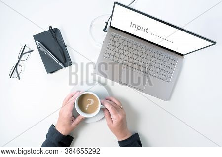 Laptop Screen Asking For Input  And Hands Of An Elderly Woman Are Holding A Coffee Cup With A Questi