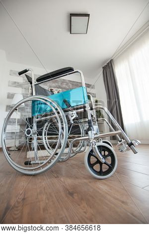 Wheelchair In A Room With Nobody In It For Patients With Walking Disability. No Patient In The Room 
