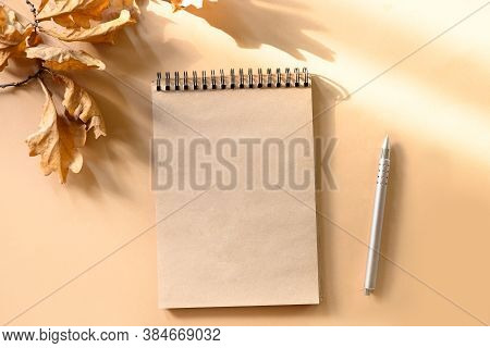 Autumn Composition Of Empty Blank, Scetchbook And Golden Dry Oak Leaves On Beige. Fall Template With
