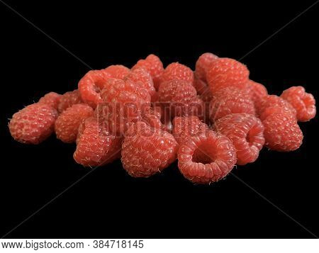 Background Texture: Red Raspberries On A Black Background. Ripe Raspberries, Close-up.