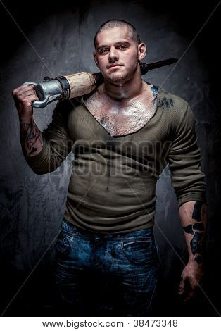 Muscular Tattooed Man With Jackhammer Posing Over Grey Background