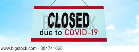 Closed COVID-19 sign hanging on window of shop. Businesses going bankrupt, barber shop, restaurants, hotels, stores, non essential services leading to economic downfall and unemployment.