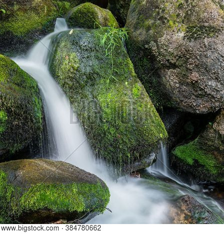 Long Exposure Of A Waterfall At Becky Falls In Dartmoor National Park