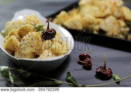 Idli Fry Made From Fermented Rice And Urad Daal Cakes Called Idis On A Dark Background.