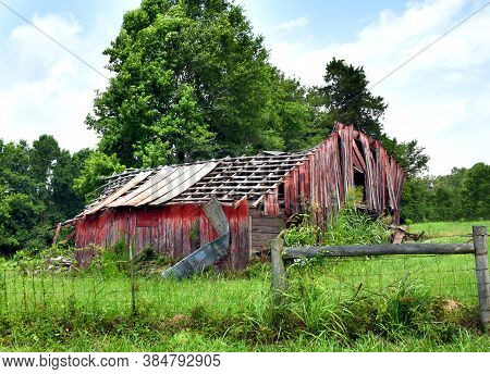 Barn In Ruins And Fence