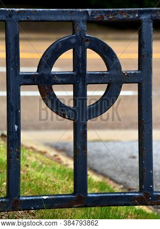 Cross In Metal Fence