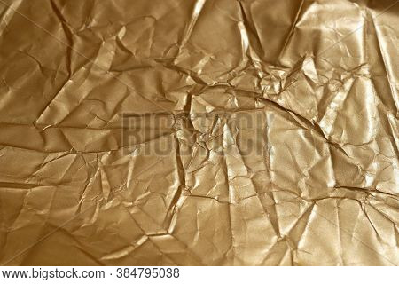 Crumpled Goldcolored Paper. Background Golden From Paper Top View. Crumpled Surface Of Brown Paper T