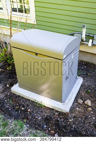 Residential Standby Generator Installed On A Concrete Pad