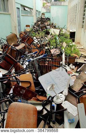 Salvador, Bahia / Brazil - October 7, 2012: Broken School Furniture Is Seen Huddled In The Courtyard