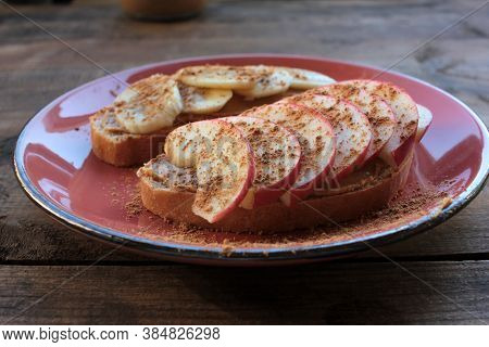 Breakfast With Peanut Butter Banana Apple Cinnamon Sandwiches On Wooden Table. Slices Of Bread With 