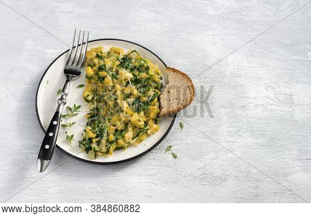 Scrumble Eggs With Kale And Cheese On A Light Gray Background, Top View. Delicious Homemade Breakfas