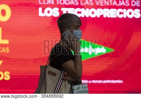 Zaragoza, Spain - August 18, 2020: A Woman Talks Throughout The Smartphone, With Face Mask, Due To T
