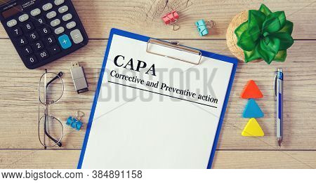 Paper With Corrective And Preventive Action Capa On The Table, Calculator And Glasses