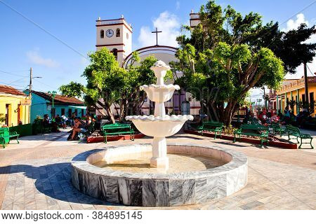 Baracoa, Cuba - December 21, 2016:  Fountain And Locals In Front Of The Catedral De Nuestra Senora D