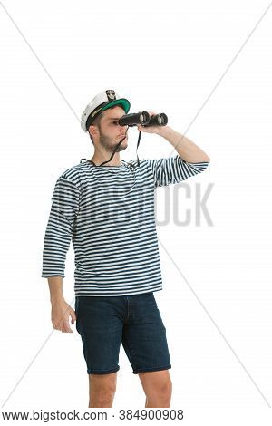 Holding Binocular. Caucasian Male Sailor In Uniform On White Studio Background. Young Man Using Mode