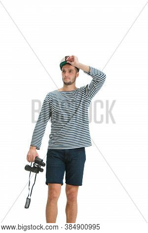 Holding Binocular. Caucasian Male Sailor In Uniform On White Studio Background. Young Man Using Mode