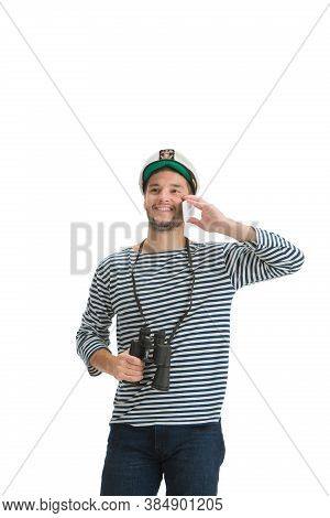 Talking Phone. Caucasian Male Sailor In Uniform On White Studio Background. Young Man Using Modern D