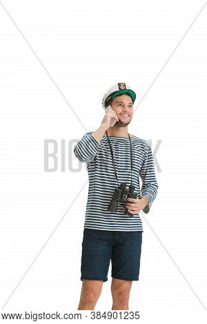 Talking Phone. Caucasian Male Sailor In Uniform On White Studio Background. Young Man Using Modern D