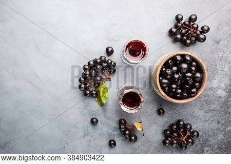 Homemade Black Chokeberry Wine Or Liqueur With Ripe Berries, Top View