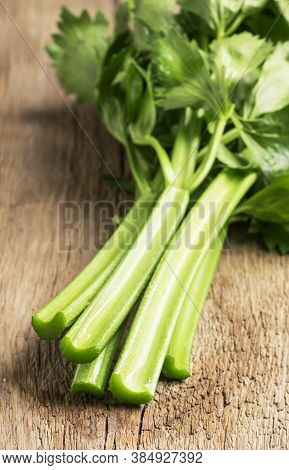 Stems Of Fresh Celery With Leaves On The Table, Vintage Wooden Kitchen Table Background, Selective F