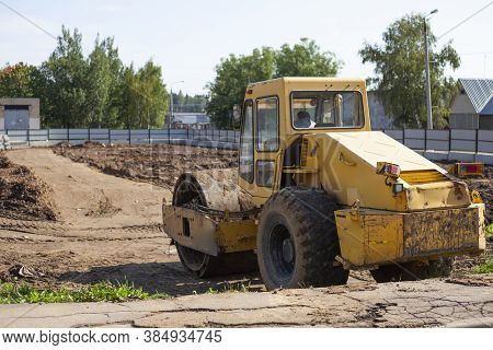 Bulldozer At A Construction Site. Heavy Construction Equipment. Sand Compactor. Multi-ton Diesel Car