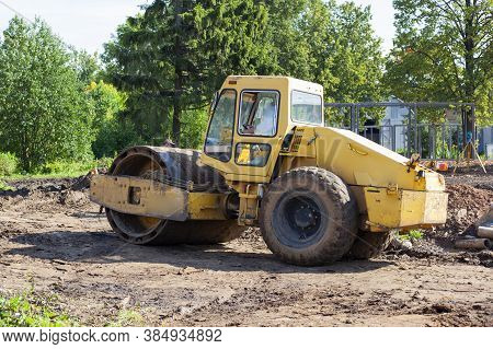 Bulldozer At A Construction Site. Heavy Construction Equipment. Sand Compactor. Multi-ton Diesel Car