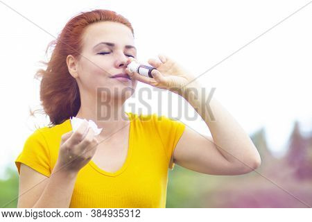Close-up. A Sick Woman Drips Into Her Nose, Drips, Sprays From Nasal Congestion, Colds And Flu. The 