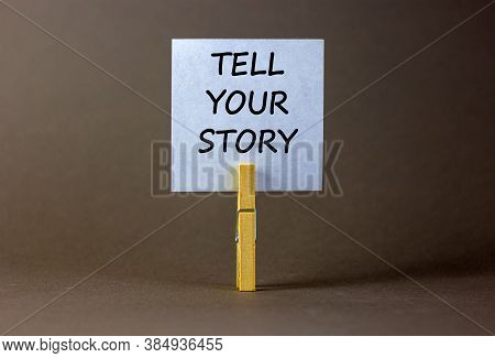 White Paper With Text 'tell Your Story', Clip On Wood Clothespin. Beautiful Grey Background. Busines