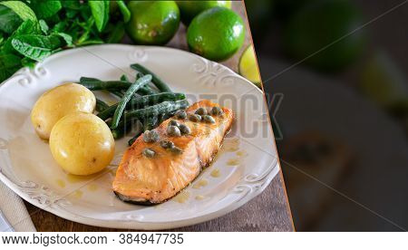 Grilled Salmon Fillet With Caper Sauce, Potatoes, Garlic, Parsley And Green Beans. Selective Focus.