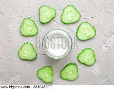 Cream On A Textured Background, With Cucumbers. Cucumber-based Cosmetics. Natural Cosmetic. Moisturi