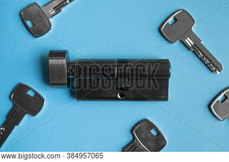 A Door Lock Cylinder Core With Keys On The Blue Background. The Cylinder Of The Lock With Keys. Inst