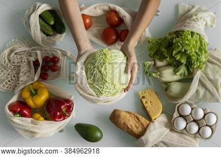 Woman Hand Holding Reusable Eco Textile Grocery Bag With Vegetables And Takes Cabage Out. Zero Waste