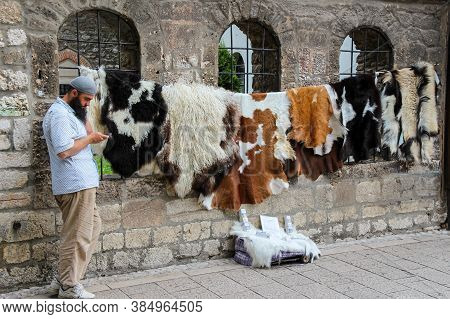 Sarajevo, Bosnia And Herzegovina - July 3rd 2018: A Muslim Street Seller, Selling Animal Skins Outsi
