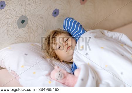 Cute Little Toddler Girl Wake Up And Sleep In Bed With Favourite Soft Plush Toy Lama. Upset Sad Baby