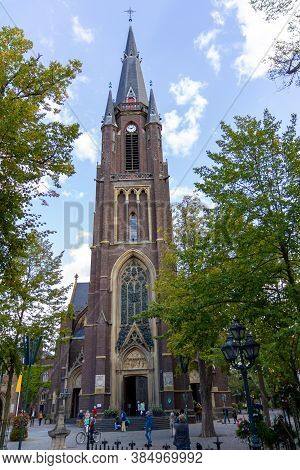 Kevelaer, Germany - Sept 5, 2020: Basilica Church With Persons In Front With Green Trees In The Summ