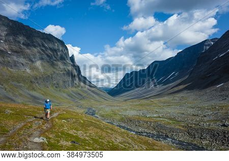 Hiking in Swedish Lapland. Man trekking alone in northern Sweden. Near Nallo mountain, Arctic nature of Scandinavia in summer day