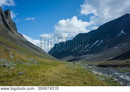 Hiking in Swedish Lapland. Man trekking alone in northern Sweden. View of Nallo mountain, Arctic nature of Scandinavia in summer day