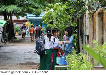 Yangon, Myanmar June 11, 2018: Three Girl Students In Myanmarese Uniform Of School (white Shirt And 