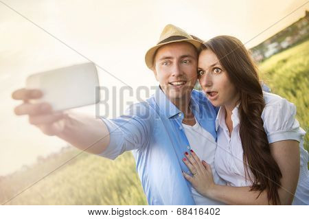 Pregnant couple taking selfie
